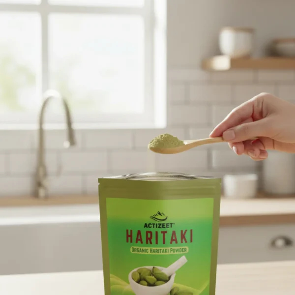 Hand scooping fine Haritaki powder from ACTIZEET pouch with wooden spoon