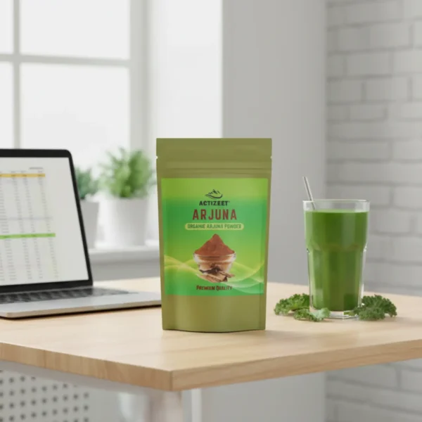 ACTIZEET Arjuna pouch on an office desk next to a laptop and green smoothie